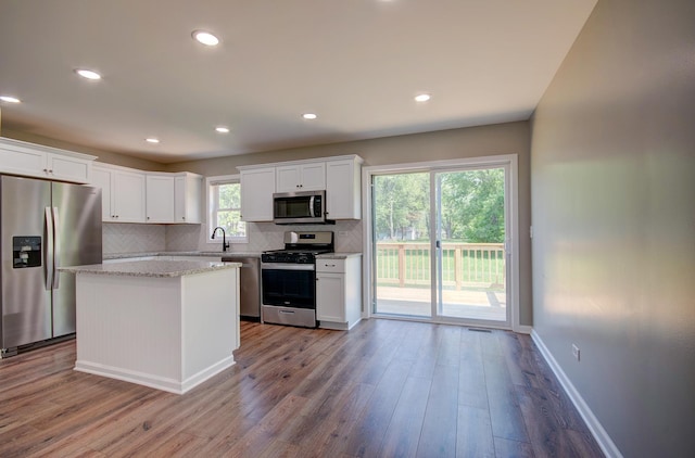 382 W 3rd St, Braidwood, IL 60408 - kitchen with stainless steel appliances, backsplash, white cabinetry, wood finished floors, and recessed lighting