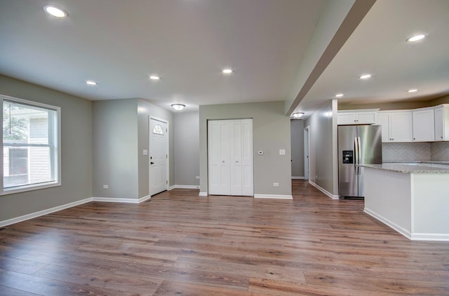 382 W 3rd St, Braidwood, IL 60408 - kitchen featuring stainless steel fridge with ice dispenser, tasteful backsplash, light wood-style flooring, white cabinets, and recessed lighting
