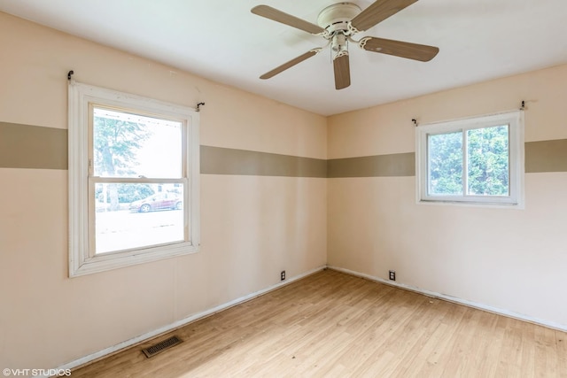 703 Hudson Ave, Romeoville, IL 60446 - unfurnished room with healthy amount of natural light, wood finished floors, and a ceiling fan