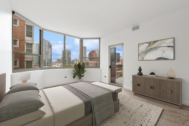 720 W Randolph St Unit 707, Chicago, IL 60661 - bedroom featuring a skyline view, access to exterior, and light carpet