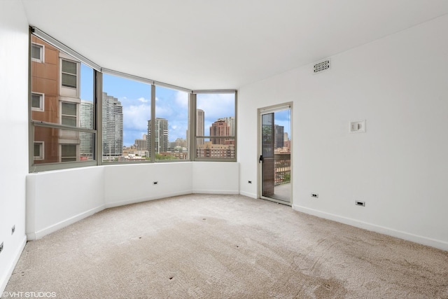 720 W Randolph St Unit 707, Chicago, IL 60661 - carpeted spare room featuring a view of skyline and baseboards