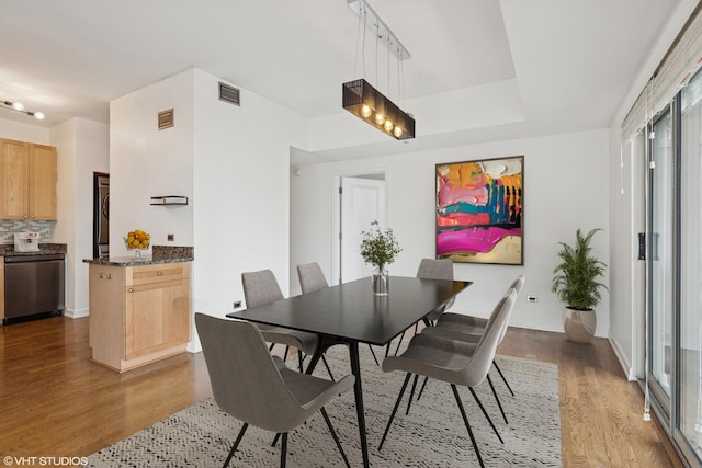 720 W Randolph St Unit 707, Chicago, IL 60661 - dining area featuring wood finished floors, plenty of natural light, and estacked washer and dryer
