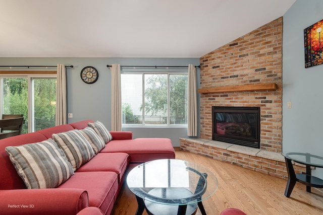 3018 Coastal Dr, Aurora, IL 60503 - living room with wood finished floors, a fireplace, and lofted ceiling