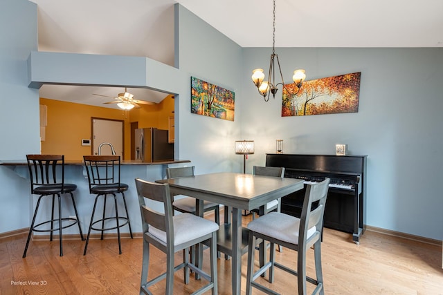 3018 Coastal Dr, Aurora, IL 60503 - dining area with light wood-style flooring, a chandelier, ceiling fan, and high vaulted ceiling