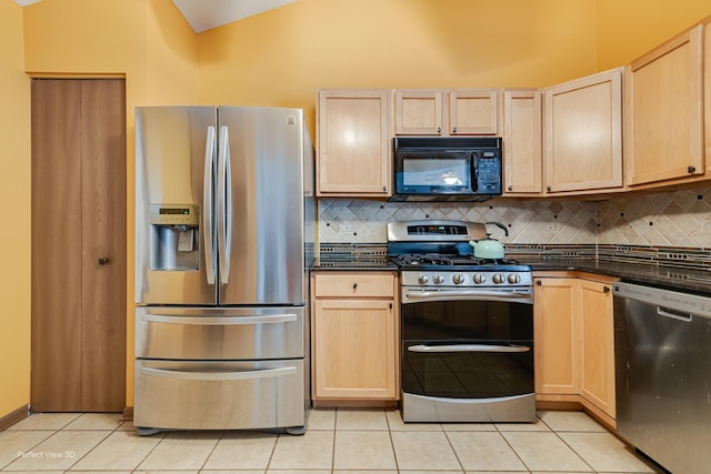3018 Coastal Dr, Aurora, IL 60503 - kitchen with appliances with stainless steel finishes, light brown cabinets, dark countertops, and lofted ceiling