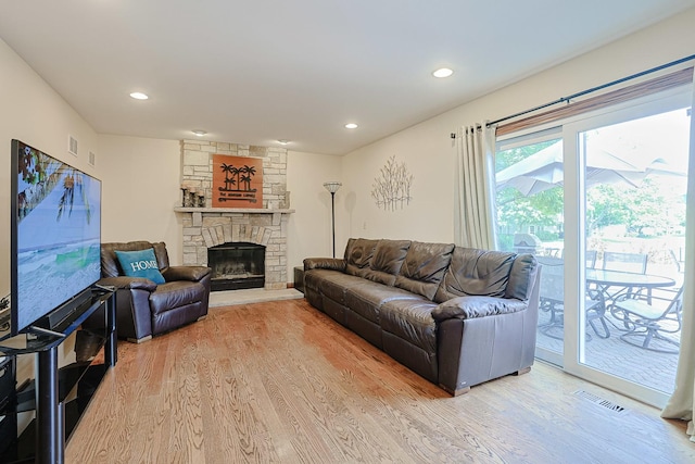 1703 Penny Ln, Bartlett, IL 60103 - living area with wood finished floors, a stone fireplace, and recessed lighting