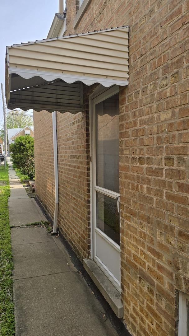 view of property exterior featuring brick siding