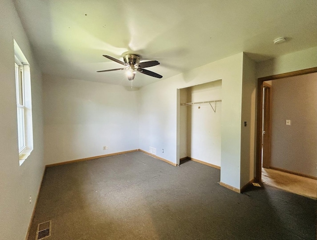 7710 E Sunset Dr, Wonder Lake, IL 60097 - unfurnished bedroom with a closet, carpet, and a ceiling fan