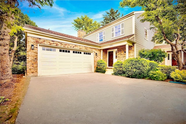 5701 Foxgate Ln, Hinsdale, IL 60521 - traditional home featuring concrete driveway, a garage, brick siding, and a chimney