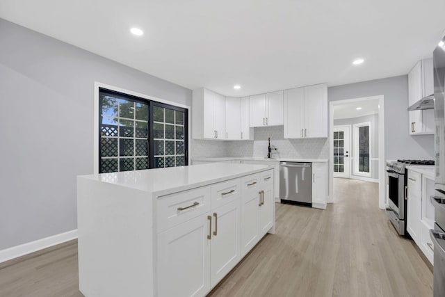 5701 Foxgate Ln, Hinsdale, IL 60521 - kitchen featuring appliances with stainless steel finishes, light countertops, light wood-style floors, white cabinets, and recessed lighting