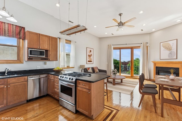 2538 W Flournoy St Unit 3, Chicago, IL 60612 - kitchen featuring appliances with stainless steel finishes, open floor plan, dark countertops, light wood-style flooring, and recessed lighting