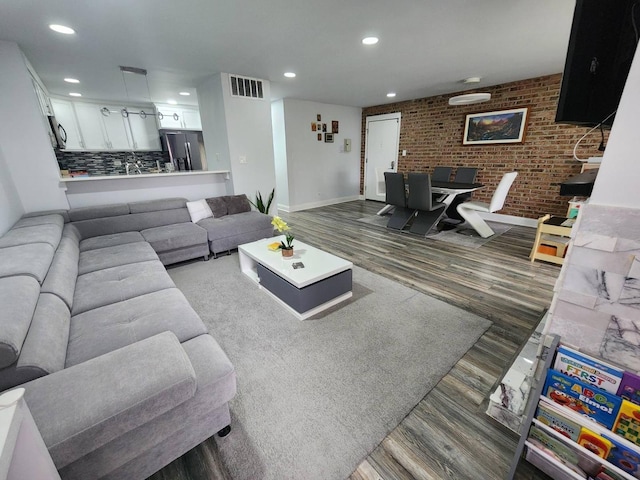 320 Sheridan Dr Unit 2C, Willowbrook, IL 60527 - living area with wood finished floors, recessed lighting, brick wall, and baseboards