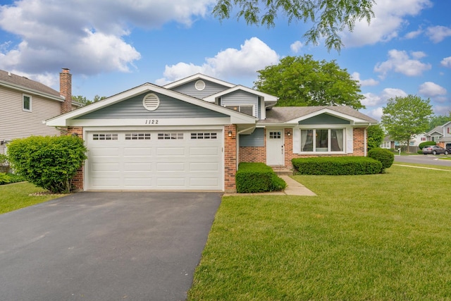 1122 N Cardinal Dr, Palatine, IL 60074 - view of front of house featuring brick siding, asphalt driveway, a garage, and a front lawn