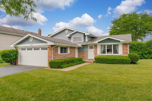 1122 N Cardinal Dr, Palatine, IL 60074 - tri-level home with asphalt driveway, brick siding, a garage, and a front lawn