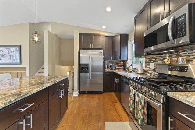 1122 N Cardinal Dr, Palatine, IL 60074 - kitchen with appliances with stainless steel finishes, a sink, lofted ceiling, light stone countertops, and light wood-type flooring