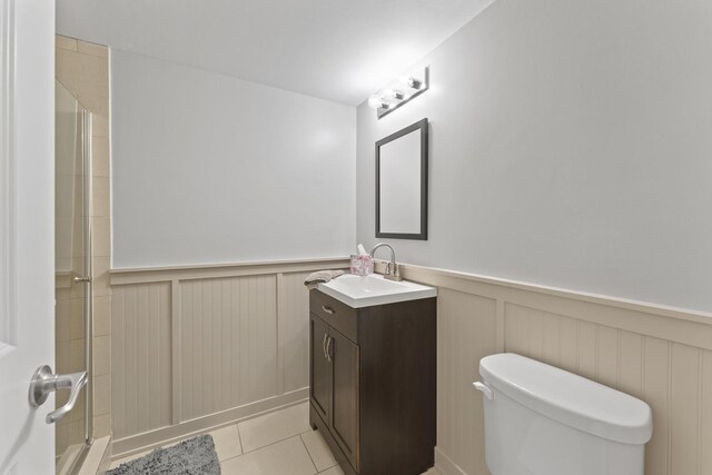 1122 N Cardinal Dr, Palatine, IL 60074 - full bathroom featuring a wainscoted wall, toilet, vanity, a shower with door, and tile patterned floors