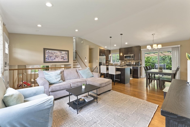 1122 N Cardinal Dr, Palatine, IL 60074 - living room featuring healthy amount of natural light, a chandelier, light wood finished floors, lofted ceiling, and recessed lighting