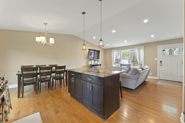 1122 N Cardinal Dr, Palatine, IL 60074 - kitchen featuring light wood-style flooring, a chandelier, lofted ceiling, light stone countertops, and hanging light fixtures