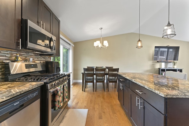 1122 N Cardinal Dr, Palatine, IL 60074 - kitchen with stainless steel appliances, vaulted ceiling, light wood-style floors, a chandelier, and dark stone counters