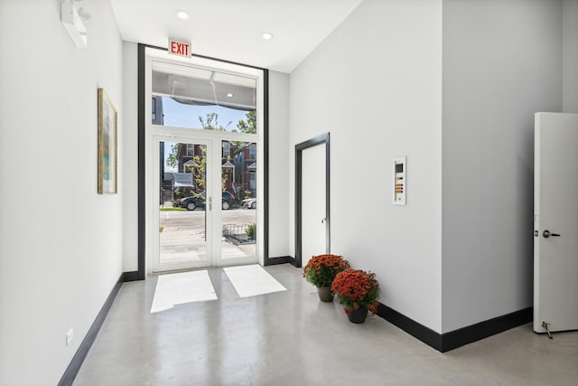 2342 W Adams St Unit 406, Chicago, IL 60612 - foyer entrance with concrete floors, baseboards, floor to ceiling windows, and recessed lighting