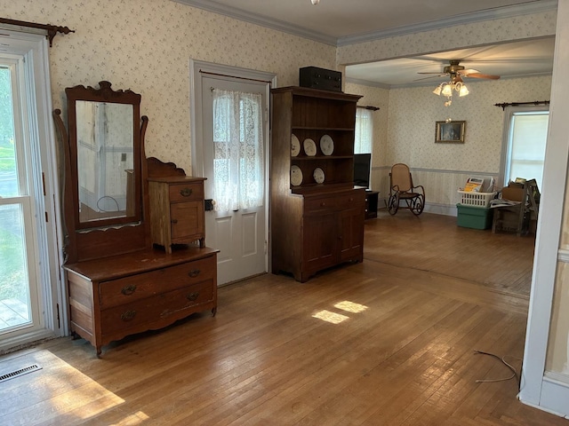 115 N Clay St, Mount Carroll, IL 61053 - dining space featuring wallpapered walls, ornamental molding, light wood-style floors, and a ceiling fan