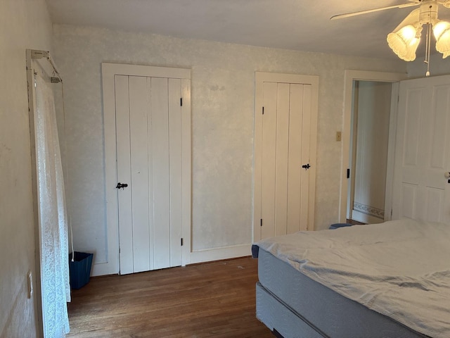 115 N Clay St, Mount Carroll, IL 61053 - bedroom featuring dark wood-style floors, ceiling fan, and baseboards