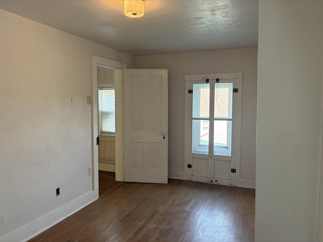 115 N Clay St, Mount Carroll, IL 61053 - spare room with wood finished floors, healthy amount of natural light, and baseboards
