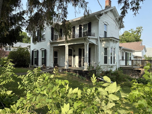 115 N Clay St, Mount Carroll, IL 61053 - italianate house with a porch and a chimney