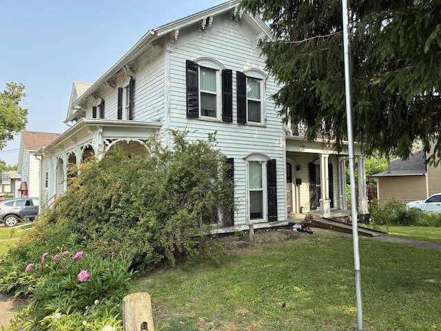 115 N Clay St, Mount Carroll, IL 61053 - italianate-style house featuring a front yard and a porch