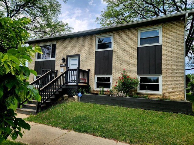 3601 W 123rd Pl, Alsip, IL 60803 - view of front of house featuring a front lawn, brick siding, and board and batten siding