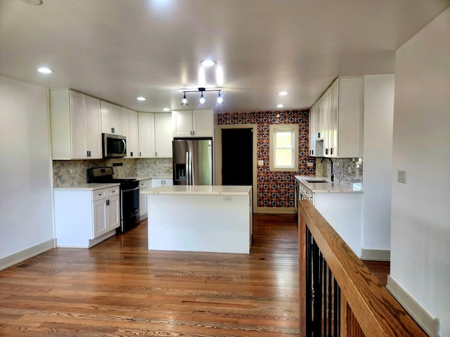 3601 W 123rd Pl, Alsip, IL 60803 - kitchen featuring stainless steel appliances, dark wood-style flooring, light countertops, a sink, and white cabinetry