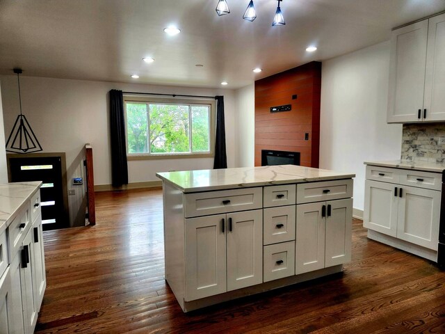 3601 W 123rd Pl, Alsip, IL 60803 - kitchen featuring dark wood-type flooring, a large fireplace, recessed lighting, decorative backsplash, and light stone countertops