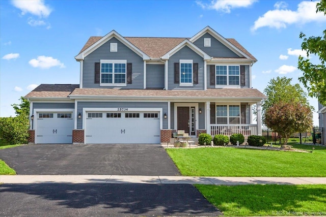 25734 Galway Ave, Plainfield, IL 60585 - view of front of home with asphalt driveway, covered porch, a front yard, an attached garage, and brick siding