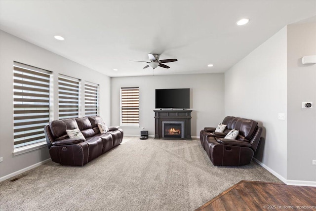25734 Galway Ave, Plainfield, IL 60585 - living area featuring a ceiling fan, a fireplace with flush hearth, recessed lighting, baseboards, and carpet