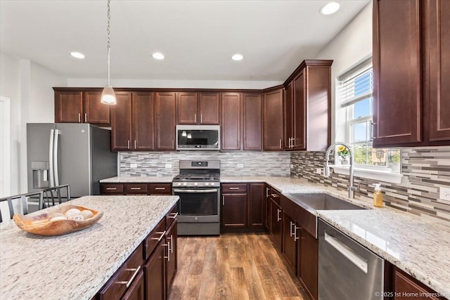 25734 Galway Ave, Plainfield, IL 60585 - kitchen with appliances with stainless steel finishes, a sink, dark wood-style floors, recessed lighting, and light stone counters