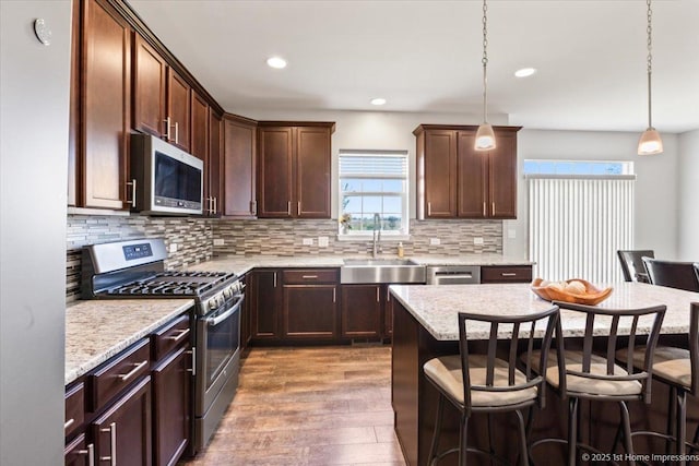 25734 Galway Ave, Plainfield, IL 60585 - kitchen featuring stainless steel appliances, a sink, a breakfast bar area, healthy amount of natural light, and recessed lighting