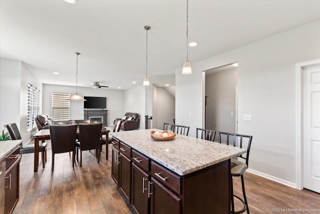 25734 Galway Ave, Plainfield, IL 60585 - kitchen featuring a kitchen breakfast bar, ceiling fan, dark wood-style floors, hanging light fixtures, and recessed lighting