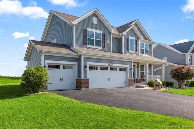 25734 Galway Ave, Plainfield, IL 60585 - view of front of property with a front yard, asphalt driveway, brick siding, and an attached garage