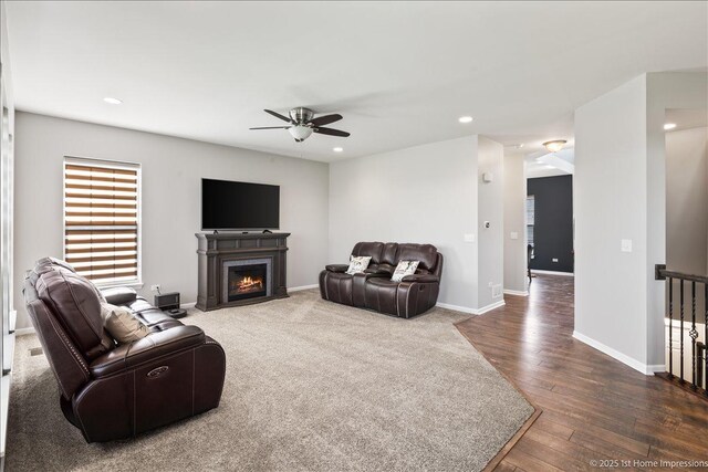 25734 Galway Ave, Plainfield, IL 60585 - living area with ceiling fan, a fireplace with flush hearth, recessed lighting, dark wood-style floors, and baseboards