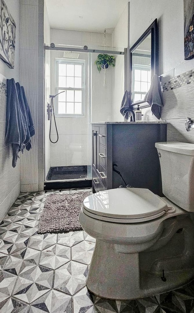 515 E Main St E, Amboy, IL 61310 - bathroom with toilet, tile patterned floors, a shower stall, and vanity