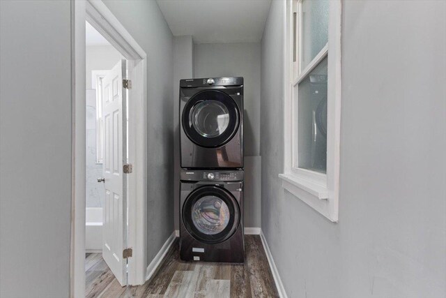 8307 S Morgan St, Chicago, IL 60620 - laundry area with estacked washer and dryer, wood finished floors, and baseboards