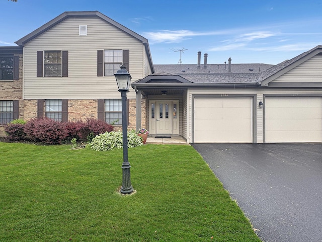 1388 Stratford Dr Unit 12-C-2, Gurnee, IL 60031 - view of front of home with an attached garage, driveway, brick siding, a front yard, and roof with shingles