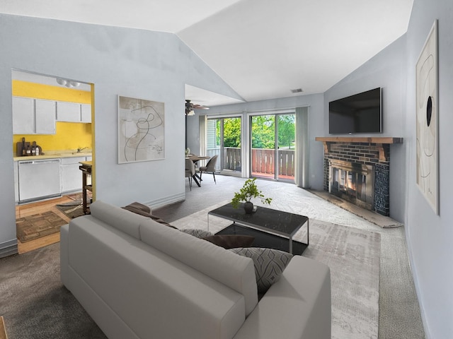 1388 Stratford Dr Unit 12-C-2, Gurnee, IL 60031 - living area featuring vaulted ceiling, carpet floors, a ceiling fan, a brick fireplace, and baseboards