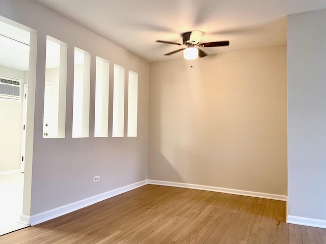 406 Franklin Ave Unit 2A, River Forest, IL 60305 - empty room with wood finished floors, ceiling fan, an AC wall unit, and baseboards