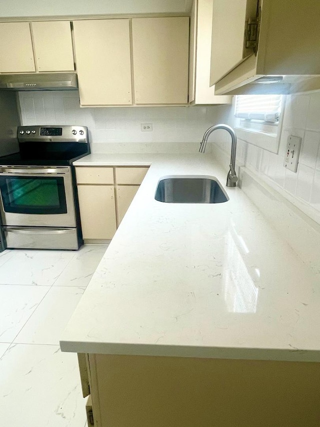 406 Franklin Ave Unit 2A, River Forest, IL 60305 - kitchen featuring stainless steel range with electric stovetop, under cabinet range hood, a sink, light countertops, and light marble finish flooring