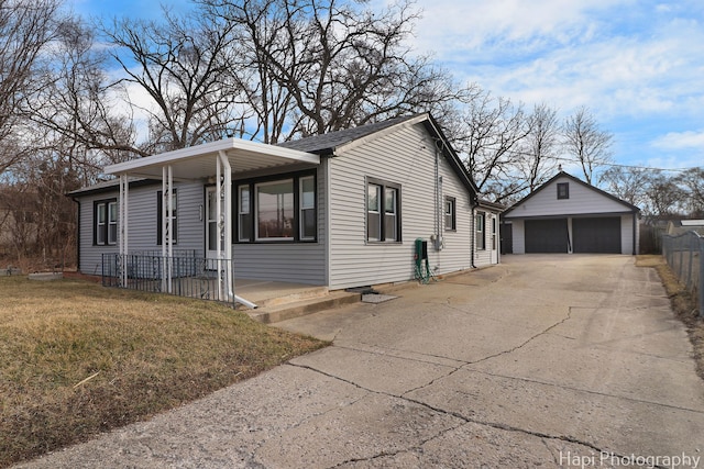 2610 S Thomas Ct, Mchenry, IL 60051 - view of property exterior featuring a garage, a porch, an outbuilding, and a yard