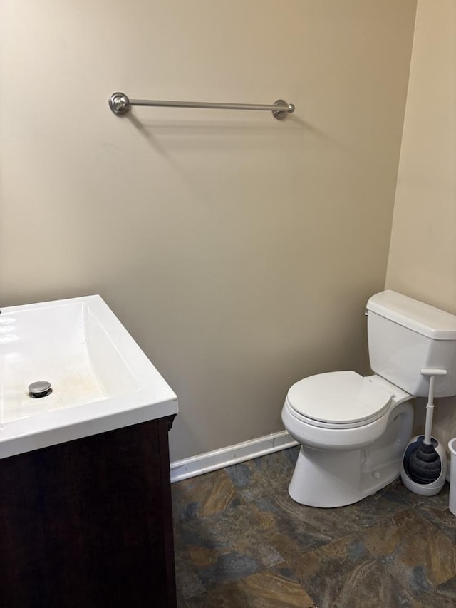 220 Harrison St, Carpentersville, IL 60110 - half bath with toilet, vanity, stone finish flooring, and baseboards