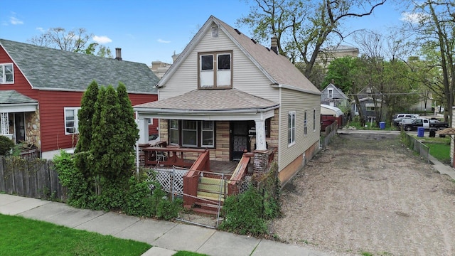 6108 S Honore St, Chicago, IL 60636 - view of front of property featuring a porch, a fenced front yard, roof with shingles, and a gate