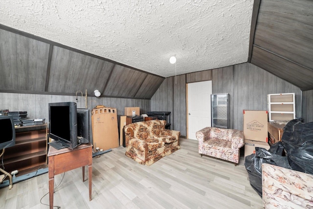 6108 S Honore St, Chicago, IL 60636 - additional living space featuring vaulted ceiling, light wood-style flooring, wooden walls, a desk, and a textured ceiling