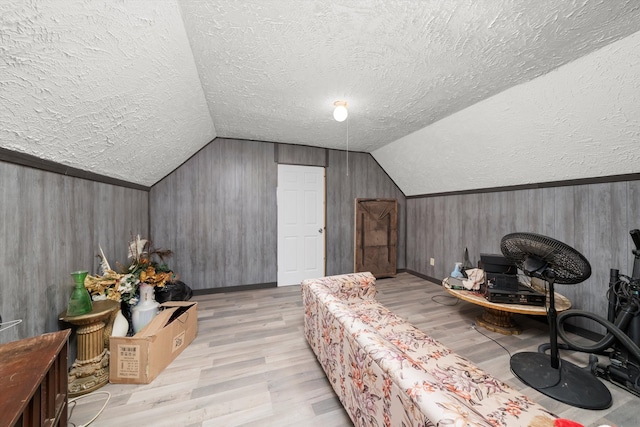 6108 S Honore St, Chicago, IL 60636 - bedroom with a textured ceiling, light wood-style flooring, vaulted ceiling, wood walls, and baseboards